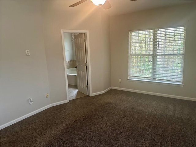 carpeted spare room featuring ceiling fan