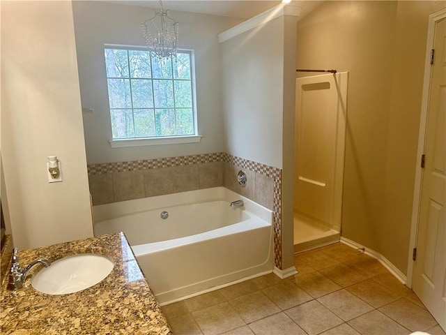 bathroom with tile patterned flooring, vanity, separate shower and tub, and an inviting chandelier