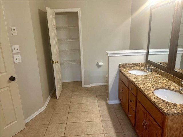 bathroom featuring toilet, vanity, and tile patterned floors