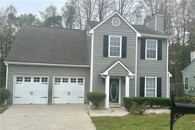 view of front of property featuring a garage and a front yard