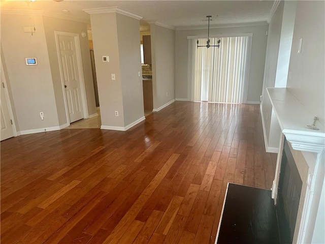 interior space with a chandelier, wood-type flooring, and ornamental molding