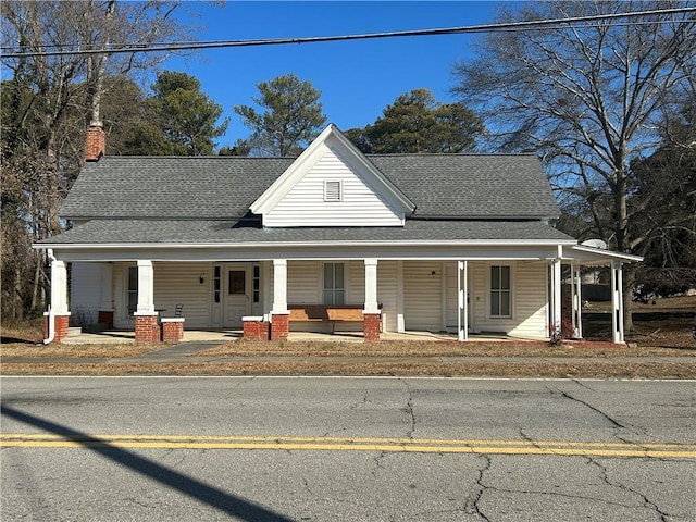 216 Hardee St, Dallas, GA 30132 - country-style home with a porch, a shingled roof, and a chimney
