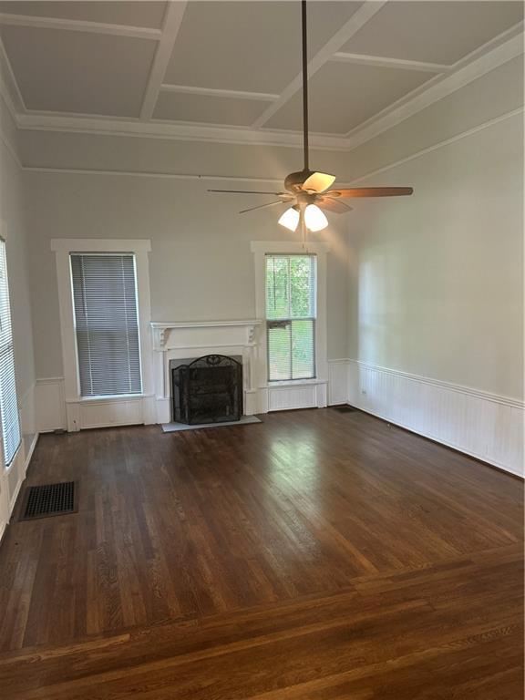 216 Hardee St, Dallas, GA 30132 - unfurnished living room featuring ceiling fan, a premium fireplace, wood finished floors, wainscoting, and ornamental molding