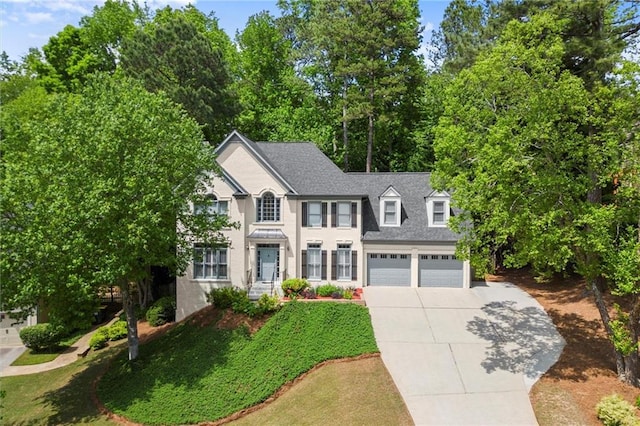 colonial home featuring driveway and a garage