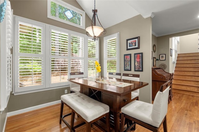 dining area with stairs, baseboards, high vaulted ceiling, and light wood-type flooring
