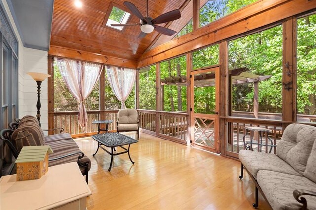 sunroom / solarium featuring a ceiling fan and a skylight