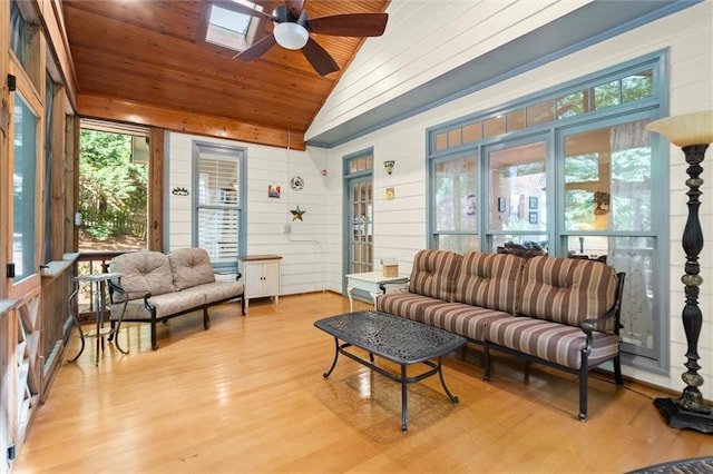 sunroom / solarium with vaulted ceiling with skylight, wooden ceiling, wood finished floors, and a healthy amount of sunlight