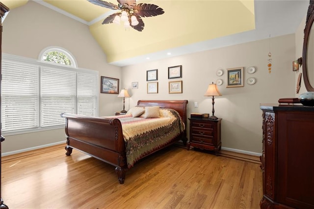 bedroom featuring baseboards, lofted ceiling, and light wood-type flooring