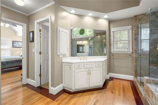 full bath with crown molding, baseboards, wood finished floors, and ensuite bathroom