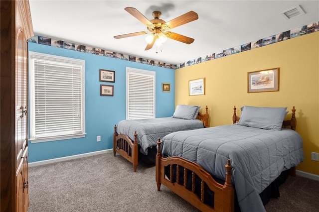 carpeted bedroom with a closet, baseboards, a ceiling fan, and visible vents