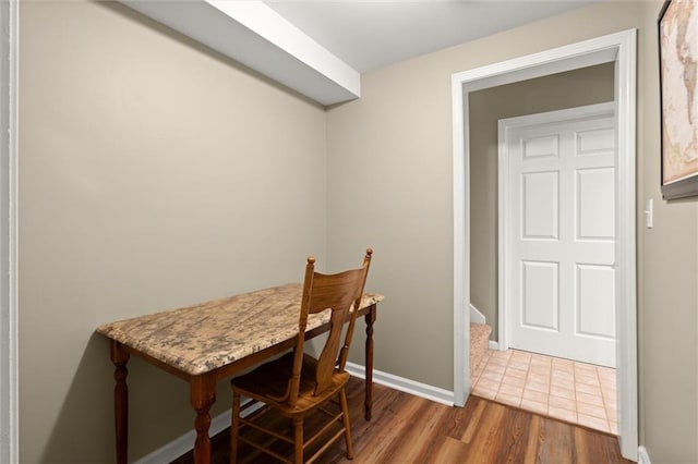 dining area featuring baseboards and wood finished floors