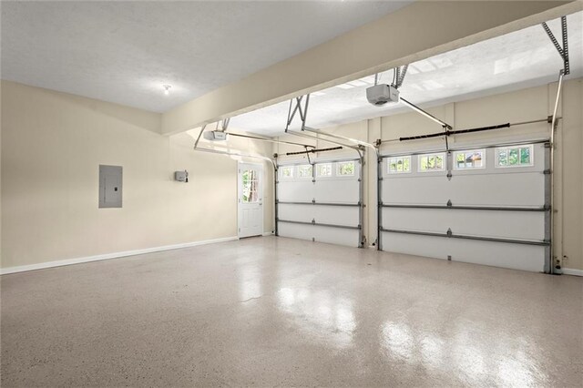 garage with baseboards, a garage door opener, and electric panel