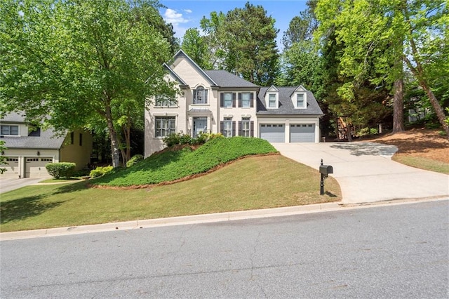 view of front of house featuring concrete driveway and a front yard