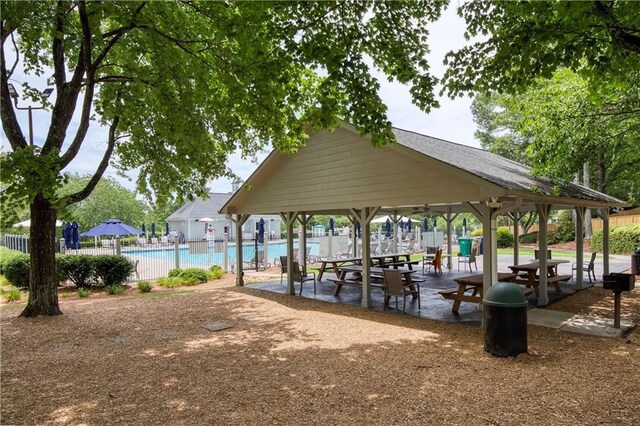 surrounding community featuring fence, a swimming pool, and a gazebo