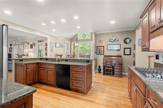 kitchen with light wood-type flooring, a sink, appliances with stainless steel finishes, and ornamental molding