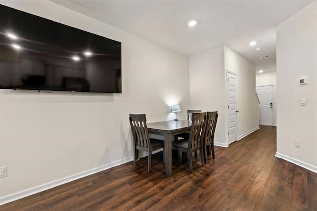 dining space featuring baseboards, dark wood-type flooring, and recessed lighting