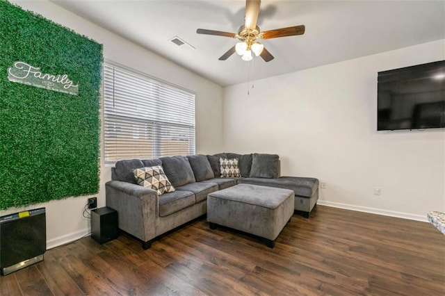 living room with ceiling fan, dark wood-style flooring, visible vents, and baseboards