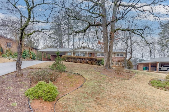 ranch-style home with a carport and a front lawn