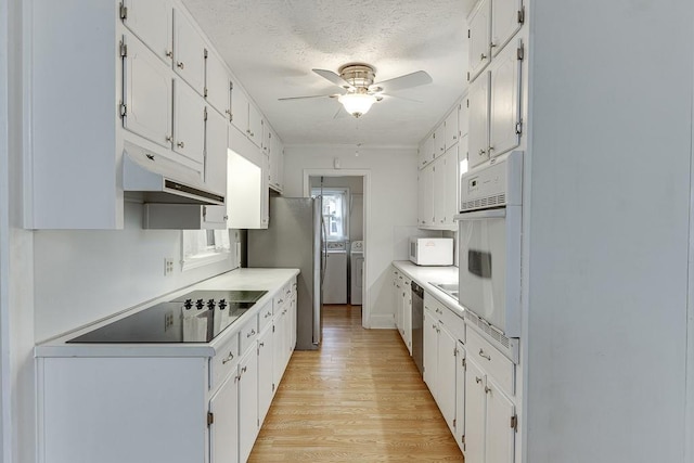 kitchen featuring separate washer and dryer, white cabinets, ceiling fan, stainless steel appliances, and light wood-type flooring