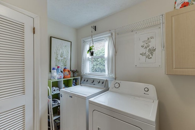 washroom with a textured ceiling and washer and clothes dryer