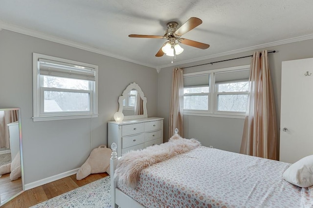 bedroom featuring multiple windows, crown molding, and light hardwood / wood-style floors