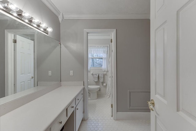 bathroom featuring crown molding, vanity, toilet, and tile patterned flooring