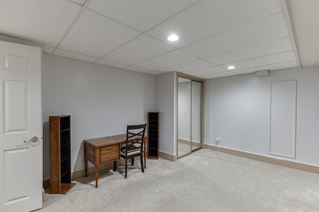 office space with a paneled ceiling and light colored carpet