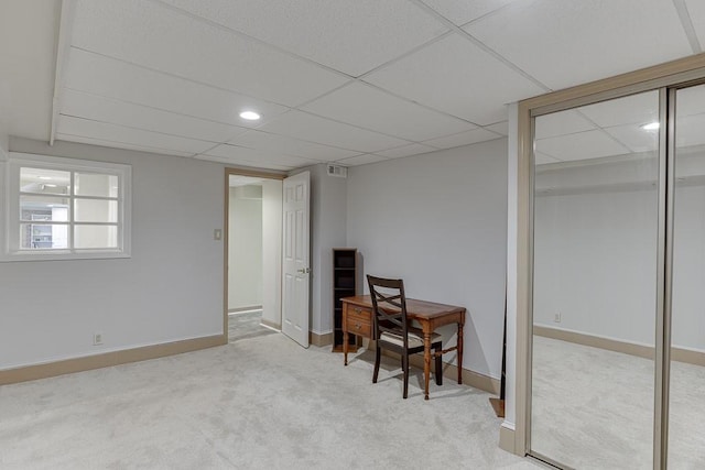 office area featuring a paneled ceiling and light colored carpet