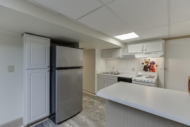 kitchen featuring a paneled ceiling, sink, stainless steel fridge, white range with electric cooktop, and light wood-type flooring