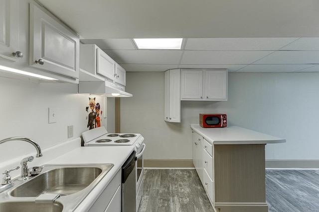 kitchen with white electric range oven, sink, white cabinetry, stainless steel dishwasher, and a drop ceiling