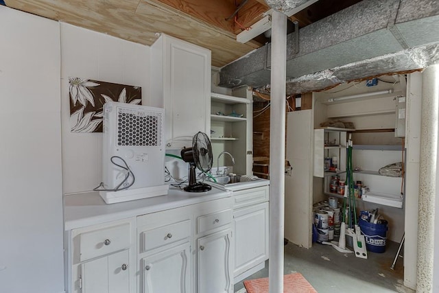 bar featuring white cabinetry and sink