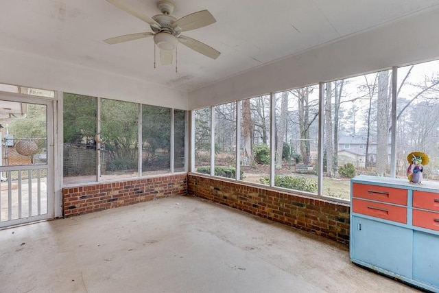 unfurnished sunroom featuring ceiling fan