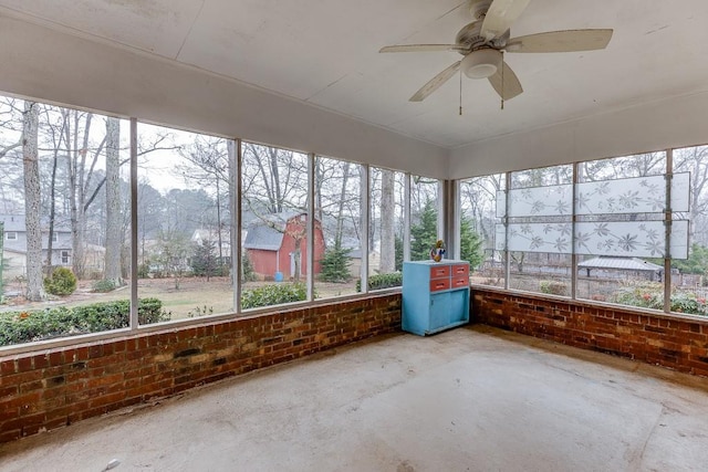 unfurnished sunroom featuring plenty of natural light and ceiling fan