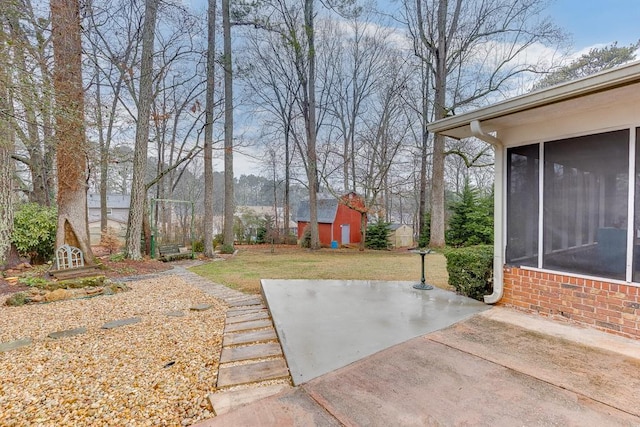 view of yard featuring a patio and a sunroom