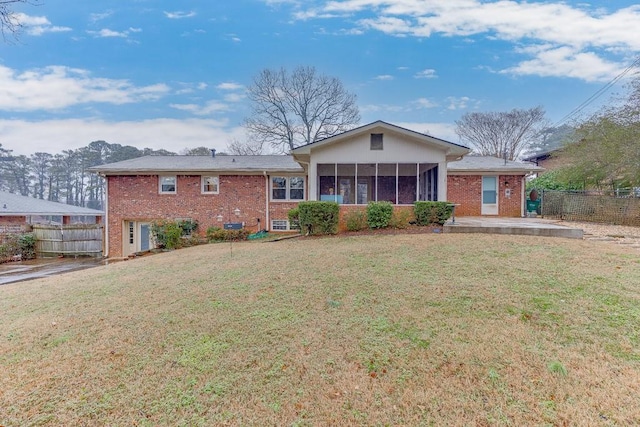 view of front of house with a front lawn, a patio area, and a sunroom