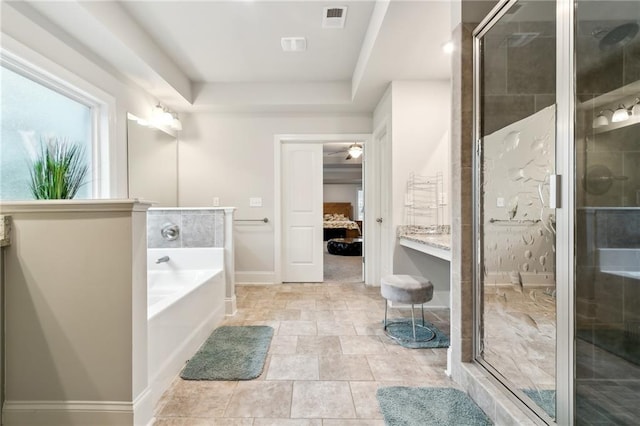 ensuite bathroom with a stall shower, visible vents, a raised ceiling, ensuite bath, and a bath