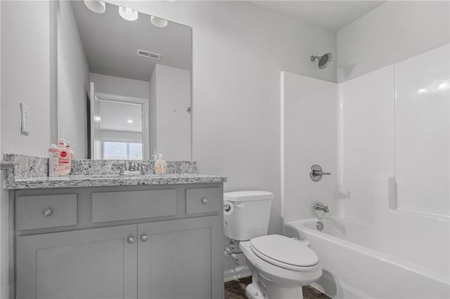 bathroom featuring toilet, visible vents, shower / bathing tub combination, and vanity