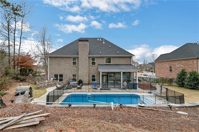 view of pool featuring a sunroom, fence, a fenced in pool, and a patio