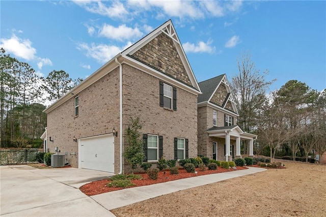 view of property exterior with an attached garage, cooling unit, brick siding, fence, and driveway