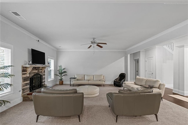 living area with ornamental molding, visible vents, a fireplace, and baseboards