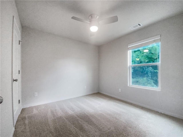 spare room featuring ceiling fan and carpet flooring