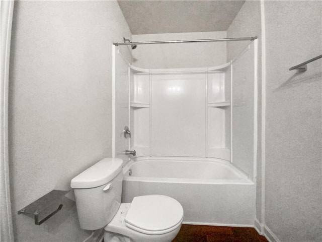 bathroom featuring bathtub / shower combination and toilet