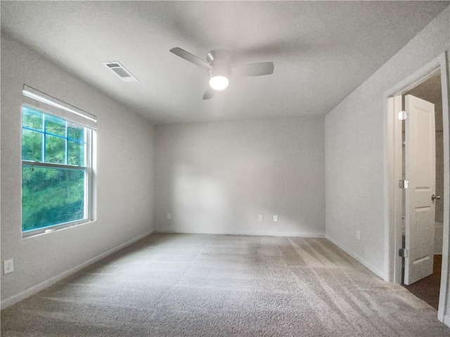 unfurnished room featuring ceiling fan and carpet