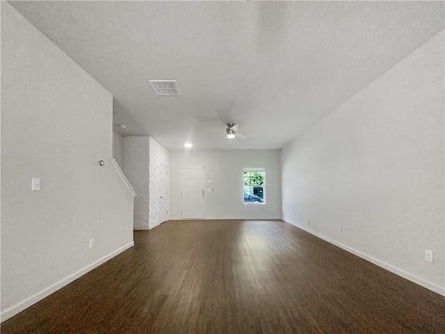 unfurnished living room featuring dark hardwood / wood-style flooring and ceiling fan