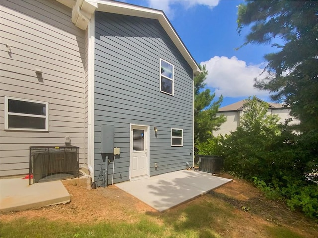 rear view of property with a patio and central air condition unit