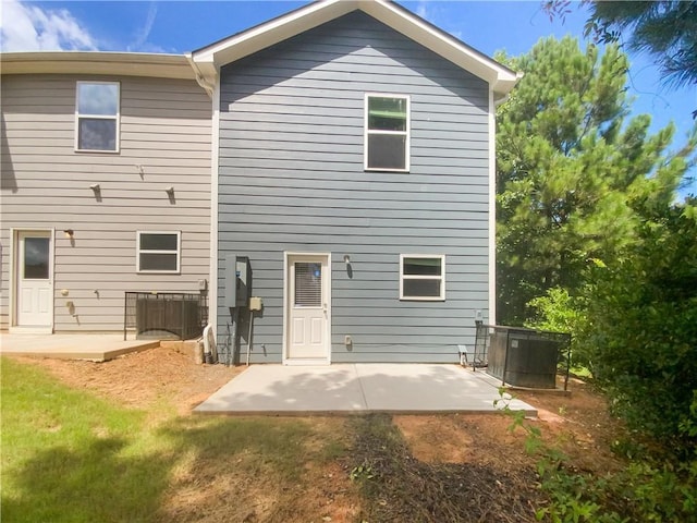 back of property with a patio area and central air condition unit