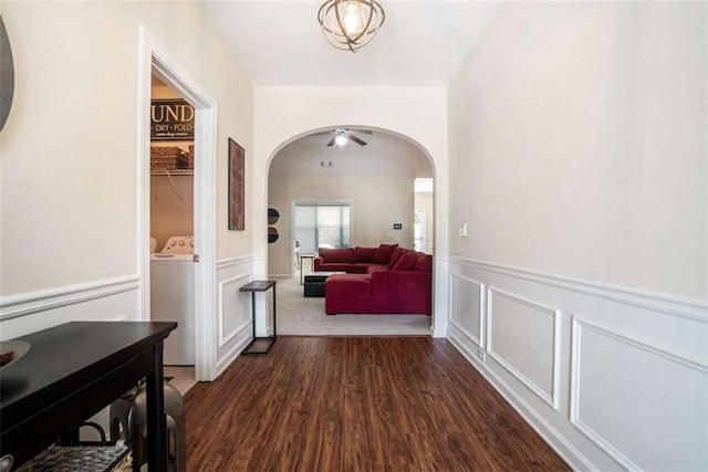 1856 Temple Park Dr, Loganville, GA 30052 - corridor featuring arched walkways, dark wood finished floors, a wainscoted wall, and a decorative wall
