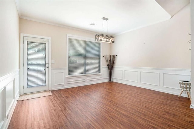 1856 Temple Park Dr, Loganville, GA 30052 - unfurnished dining area featuring ornamental molding, wood finished floors, a wainscoted wall, a chandelier, and a decorative wall