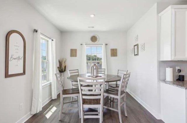 dining space with dark wood-type flooring