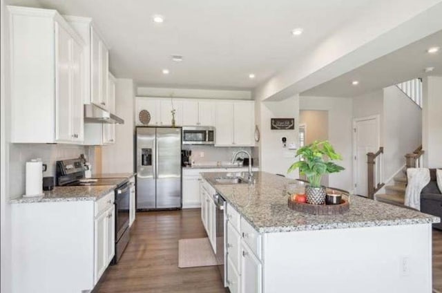 kitchen with white cabinetry, an island with sink, and appliances with stainless steel finishes